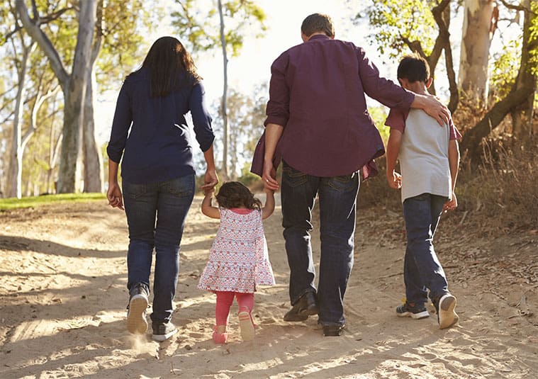 Couple walking with their two children - Maines Legal.