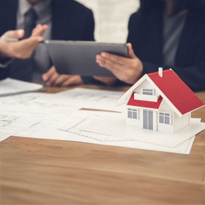 Lawyers analyze estate planning with a house model